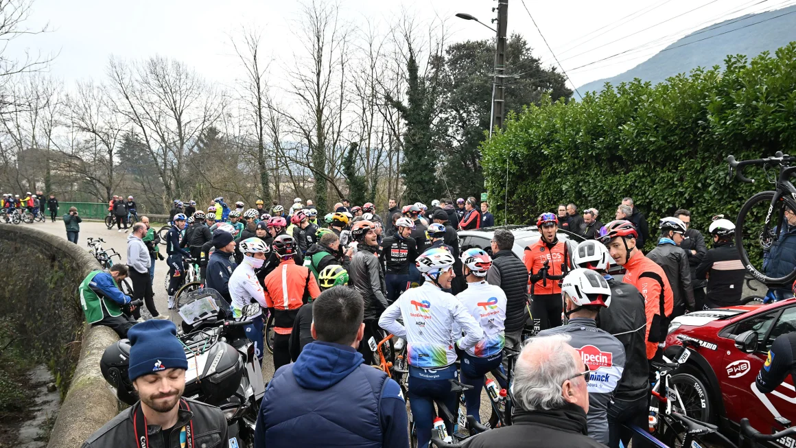 Cycling race upended by riders' mass protest after cars on the course prompts chaos